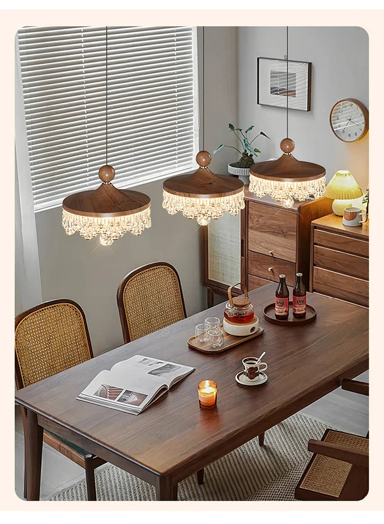 Three Maison Ornate French Medieval Style Crystal Teardrop Chandeliers emit elegant, warm illumination.
