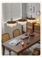 Three Maison Ornate French Medieval Style Crystal Teardrop Chandeliers emit elegant, warm illumination.