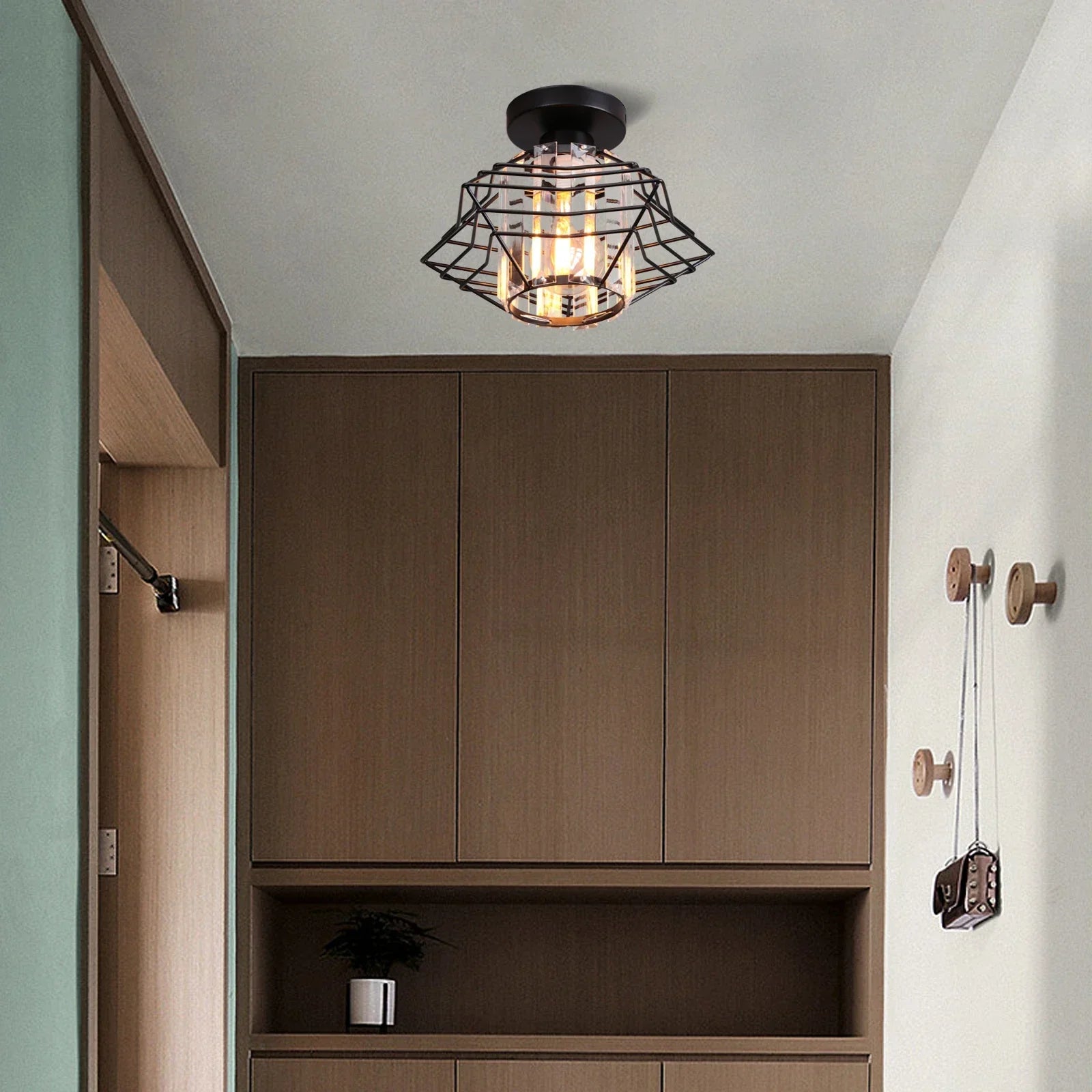 Maison Ornate Crystal Hallway Chandelier with black metal cage and exposed bulb, modern industrial style.