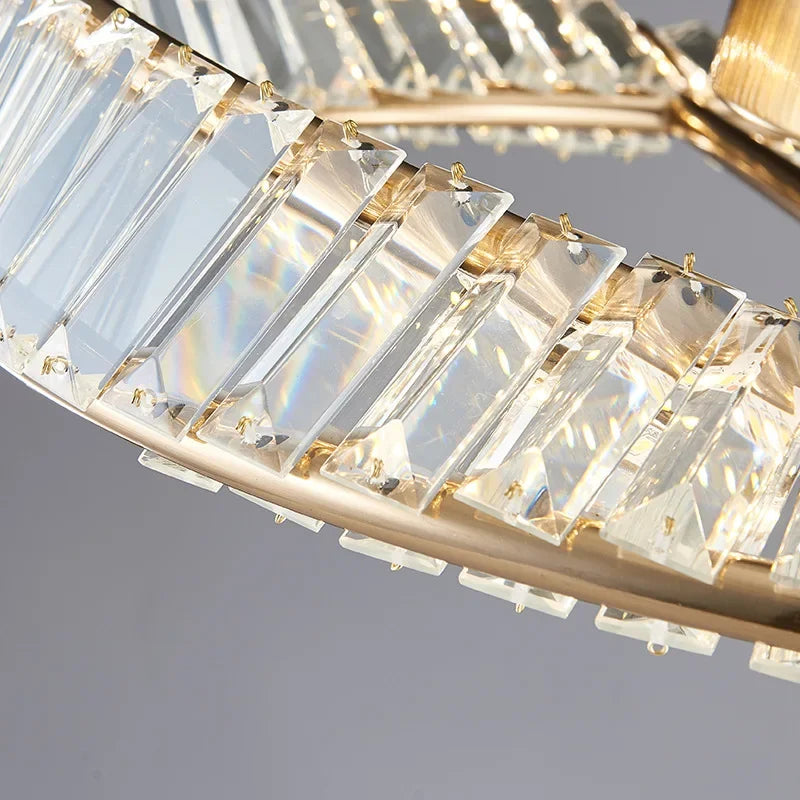 Maison Ornate Modern Dimmable LED Crystal Glass Chandelier with rings and triangular prisms, reflecting rainbow light.