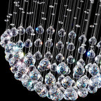 Modern spherical crystal chandelier with glass teardrops and polished steel reflects multicolored LED light.