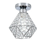 Modern chandelier with geometric metal frame, circular clear crystals, and chrome base for elegant lighting.