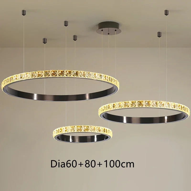Three Maison Ornate Luxury Crystal Chandeliers in 60, 80, and 100 cm, staggered, emit warm yellow light.