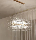 Gold bar chandelier with elegant crystal branch details and LED lights; sophisticated, luxurious lighting fixture.