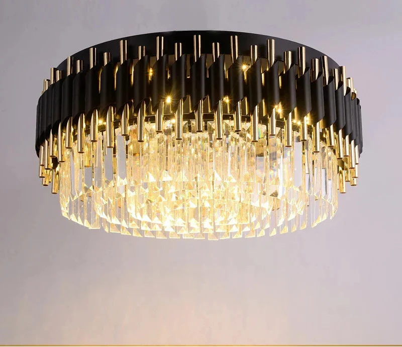 Circular black chandelier with gold rods and crystal prisms, emitting a warm decorative glow.
