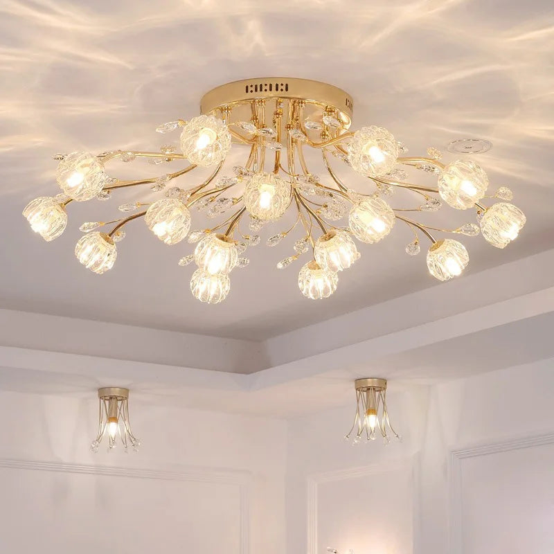 The Maison Ornate Golden Crystal LED chandeliers feature radiant glass floral designs and intricate detailing.