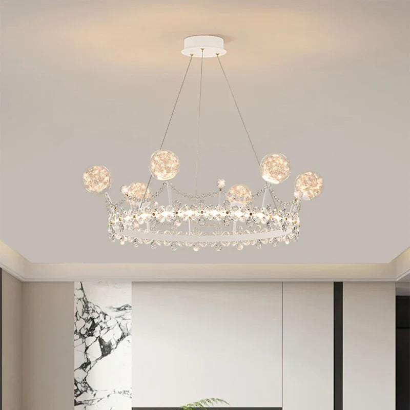 Crown-shaped crystal ball chandelier with globe lights and ornate details for kids' rooms.