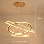 Gold-finished chandelier with three dimmable LED crystal rings, suspended by cables, modern design.