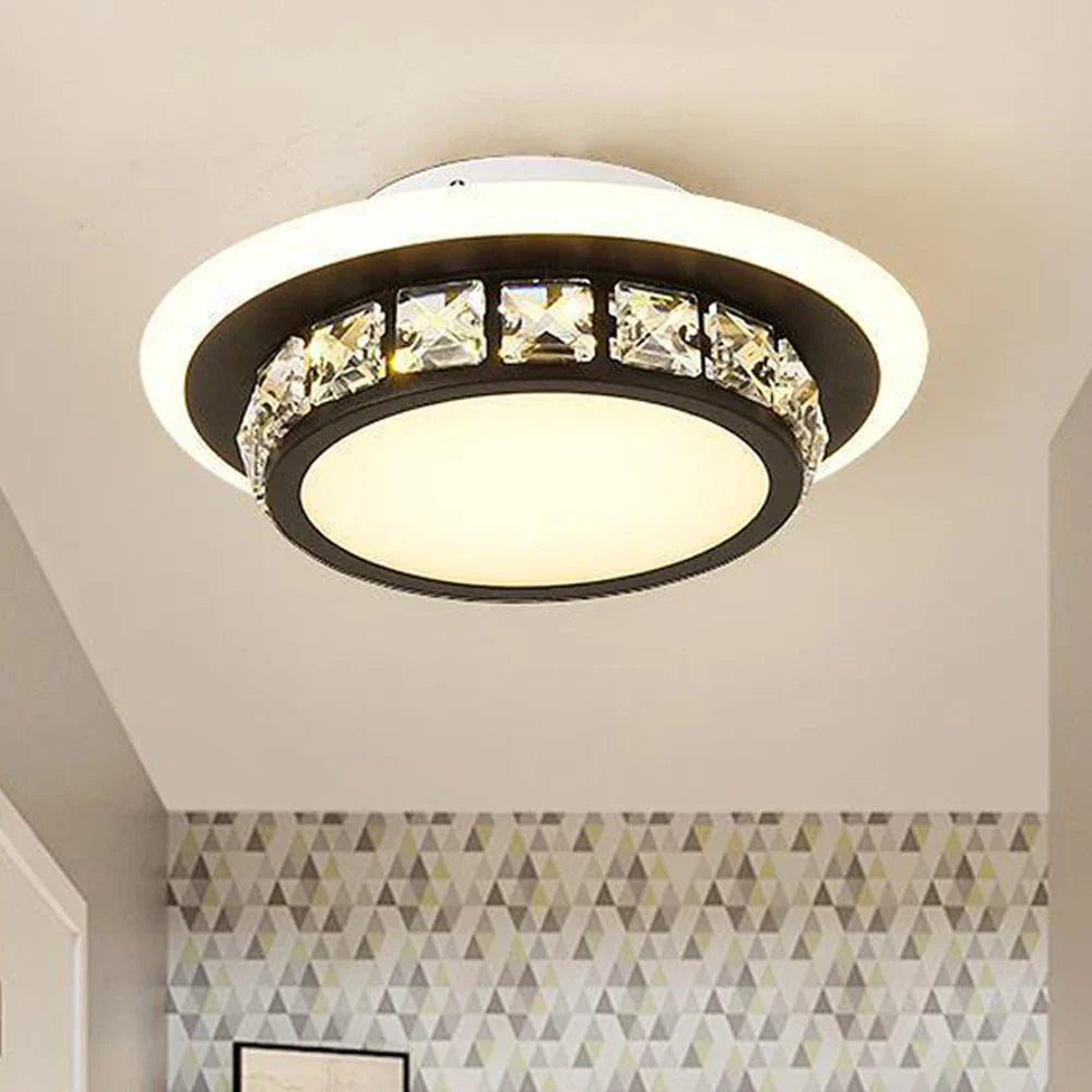 The Maison Ornate LED chandelier features circular design and faceted crystal accents for modern elegance.