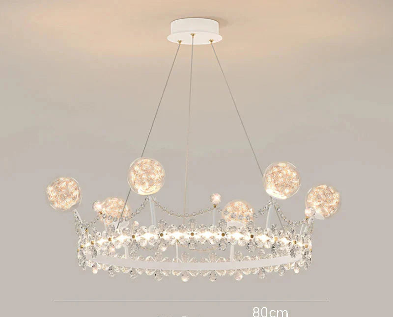 Whimsical crown-shaped chandelier with sparkling crystals and glass orbs, ideal for stylish kids' rooms.