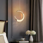 Modern crystal chandelier with gold accents by Maison Ornate, elegantly glowing and product-focused.