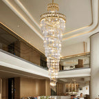 Elegant modern crystal chandelier with gold accents, multiple tiers, and warm lighting. Ideal for luxury spaces.