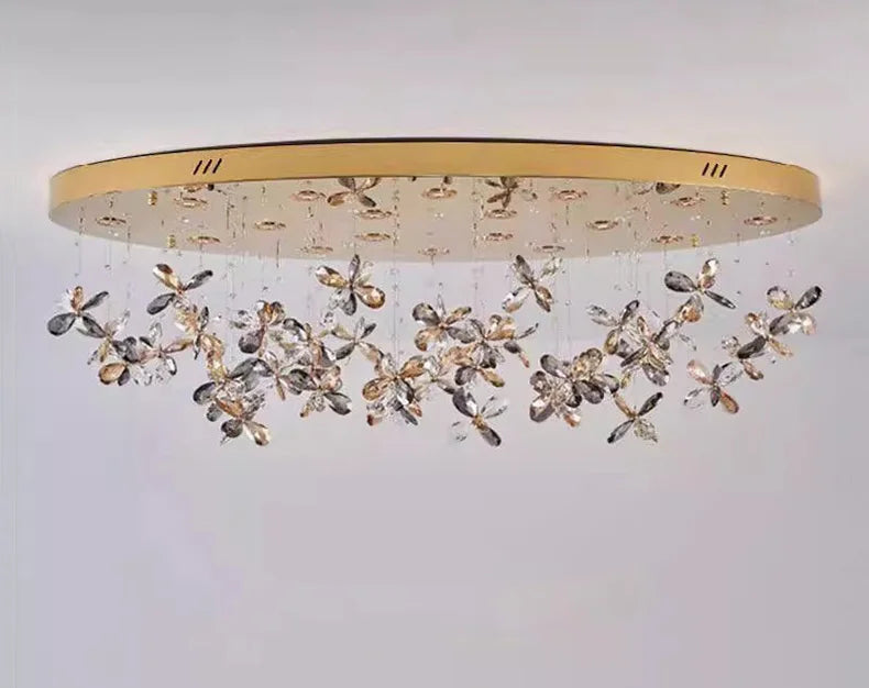 Modern crystal LED chandelier with gold oval base and clustered crystal flower pendants. Contemporary elegance.