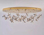 Modern crystal LED chandelier with gold oval base and clustered crystal flower pendants. Contemporary elegance.
