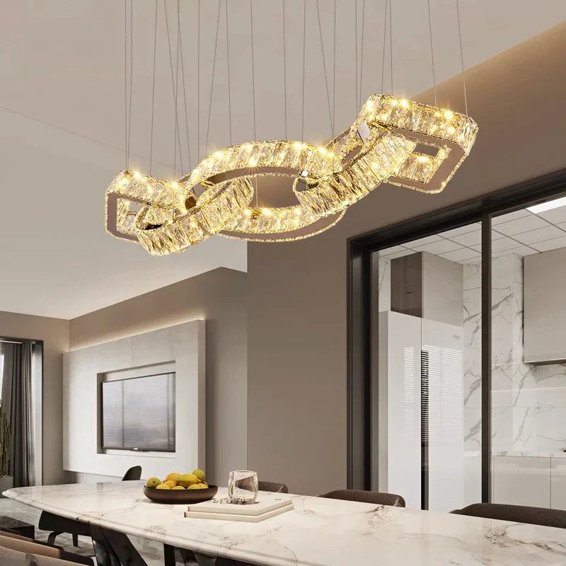 Maison Ornate Modern Gold Crystal Pendant Lighting with intertwined rectangles emits a stylish, warm glow.