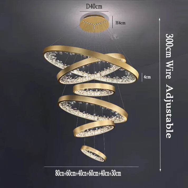 Five gold LED ring chandelier tiers, 80–30 cm wide, adjustably suspended by slim wires.