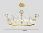 Gold crown-shaped chandelier with crystal balls, beads, and four suspension wires; 80 cm wide.