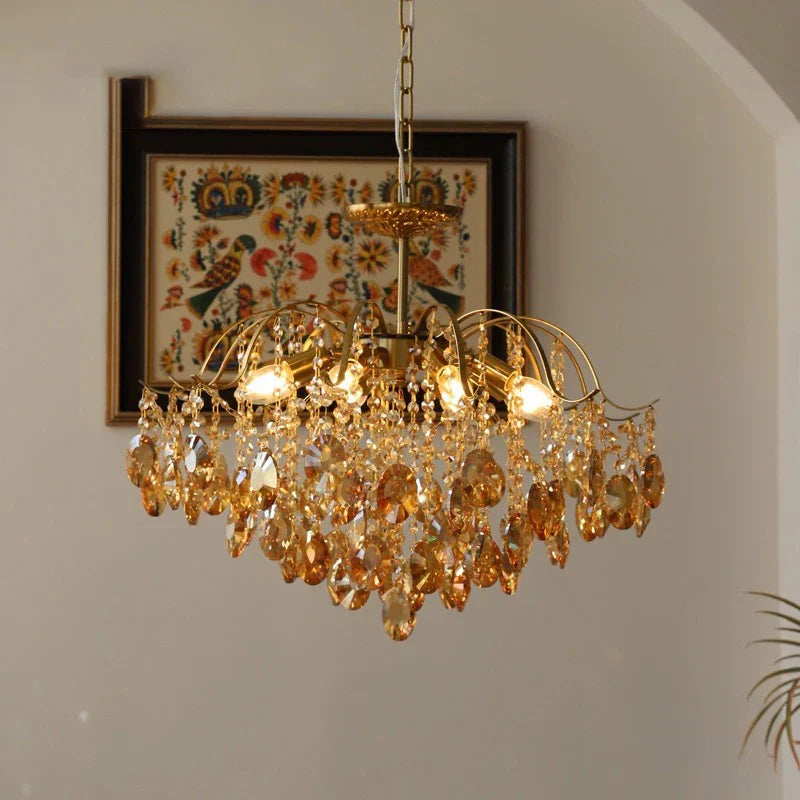 Elegant vintage crystal chandelier with amber ornaments, ceiling-mounted, beautifully illuminated for retro charm.