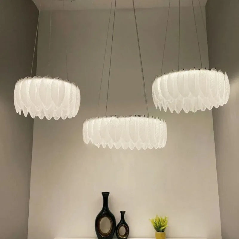 Three Crystal Ball Chandeliers with glass and decorative feathers by Maison Ornate, showcasing Nordic elegance.
