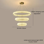 Modern LED crystal chandelier with three circular tiers, dimmable light, adjustable wires, and sparkling crystal accents.
