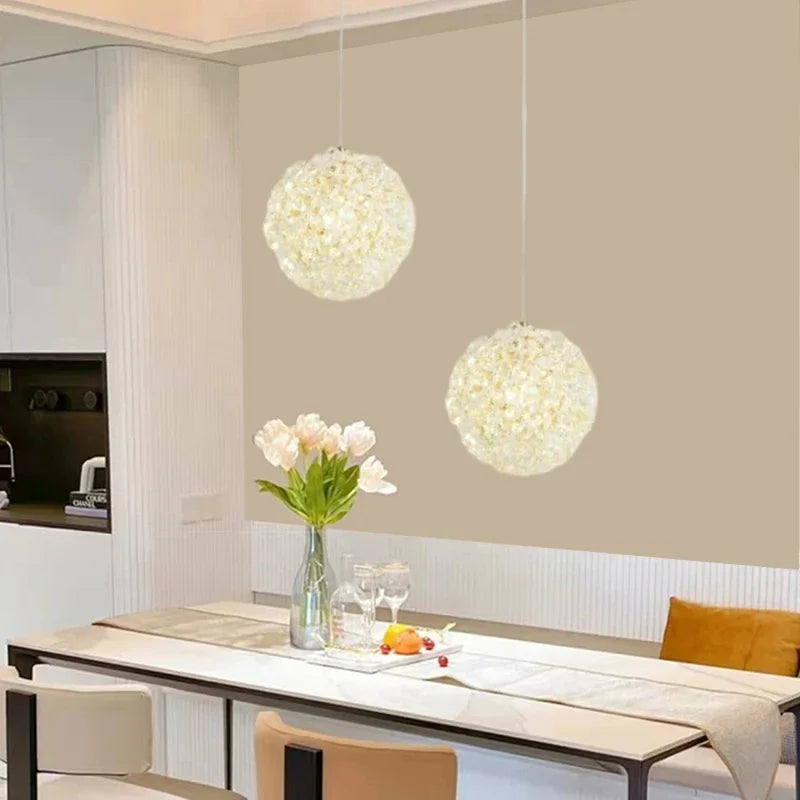 Two Maison Ornate Modern Crystal Ball Chandeliers with artistic design elegantly suspended above.