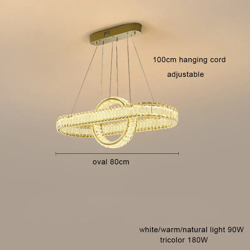 Oval crystal LED chandelier with four adjustable cords, rectangular ceiling mount, dimmable tri-color lighting.