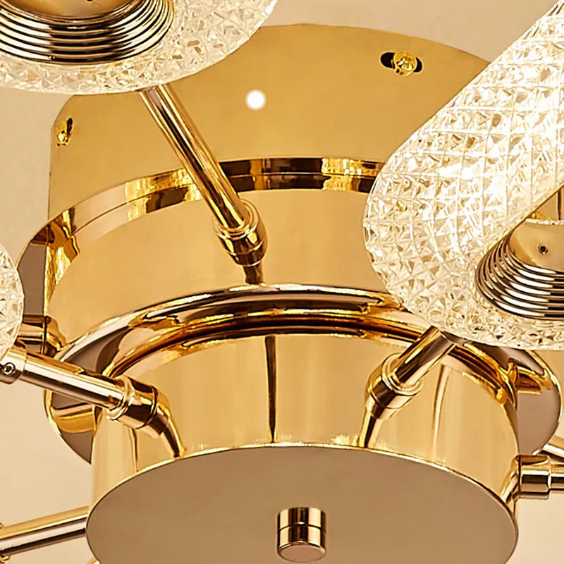 Close-up of Maison Ornate LED Crystal Chandelier with textured glass shades and polished gold finish.