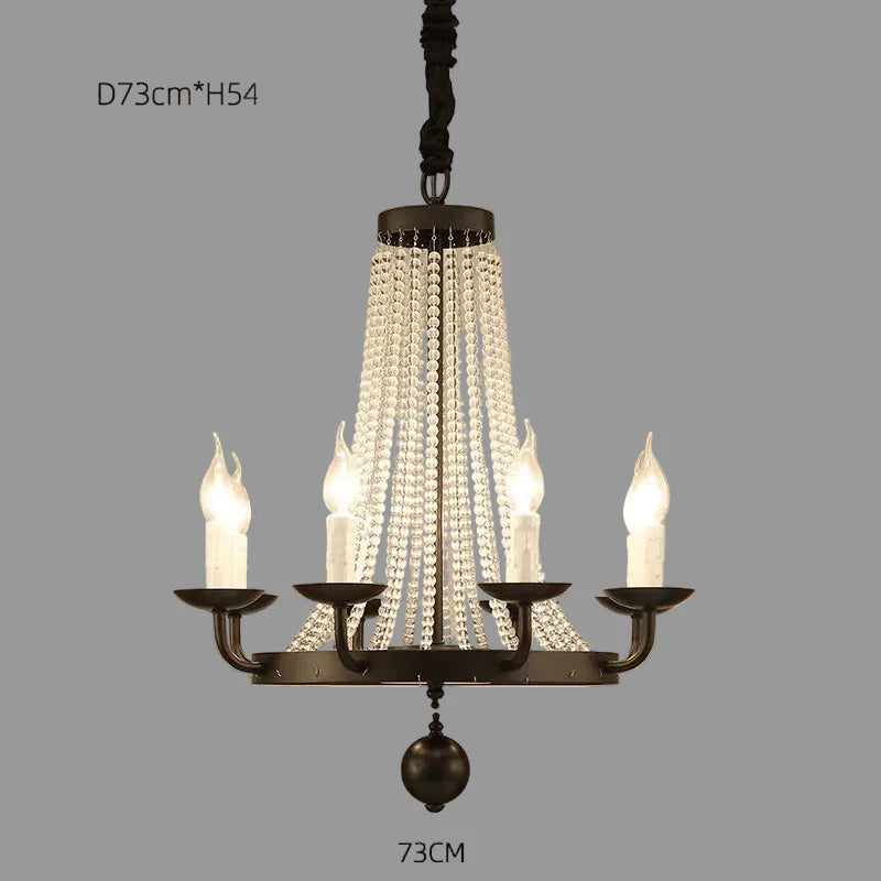 Elegant Maison Ornate chandelier with five candle lights, crystal beads, gold accents, and tassels.