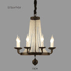 Elegant Maison Ornate chandelier with five candle lights, crystal beads, gold accents, and tassels.