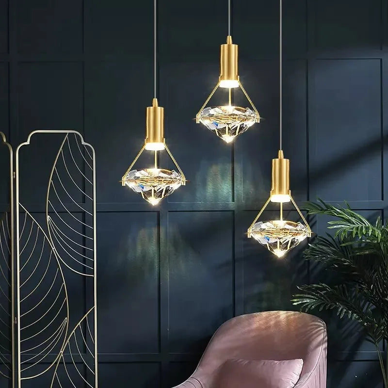 Three Nordic diamond design crystal chandeliers with gold fixtures and ornate crystal detailing.