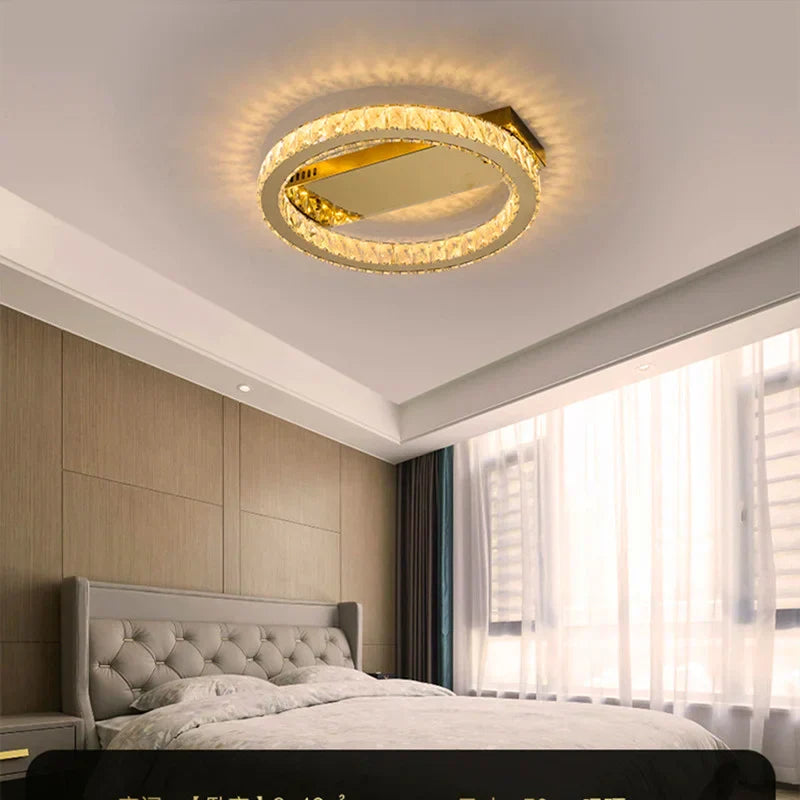Maison Ornate Modern Crystal Lustre chandelier in stainless steel casts a warm, elegant glow overhead.