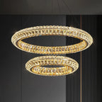 Two Maison Ornate modern crystal LED chandeliers with staggered heights, warm golden glow.