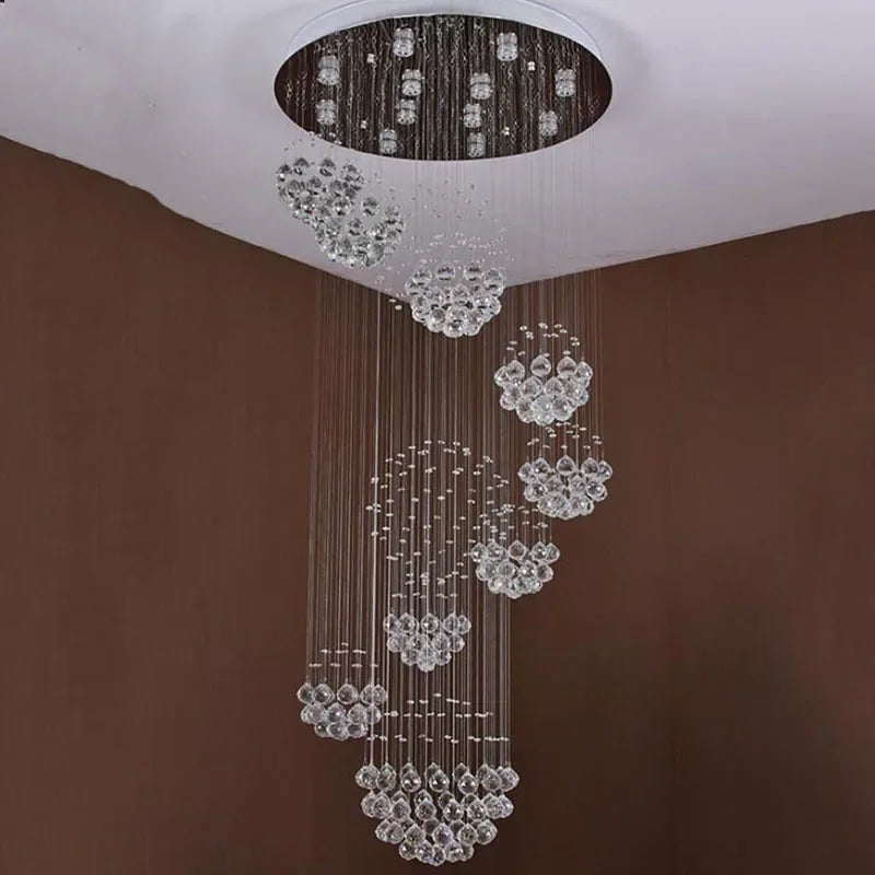 Modern crystal chandelier with stainless steel mount, thin wires, and clusters of cascading crystal balls.
