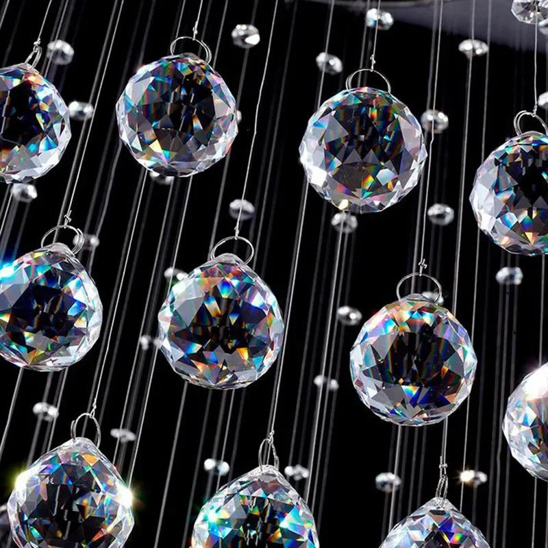Close-up of Maison Ornate Modern Spherical Crystal Chandelier, polished steel with faceted crystal balls.