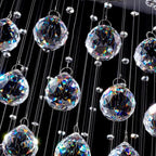 Close-up of Maison Ornate Modern Spherical Crystal Chandelier, polished steel with faceted crystal balls.