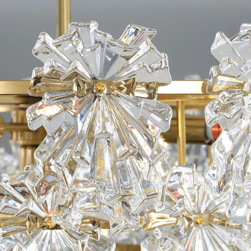 Ornate brass chandelier with crystal-like glass flowers and gold accents, elegant and sparkling.