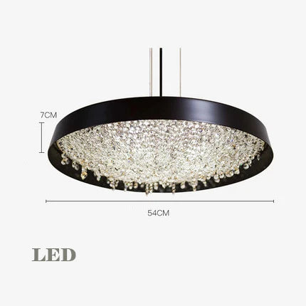 Black-framed chandelier with crystal accents, 54 cm wide, 7 cm high, hung by slim cables.