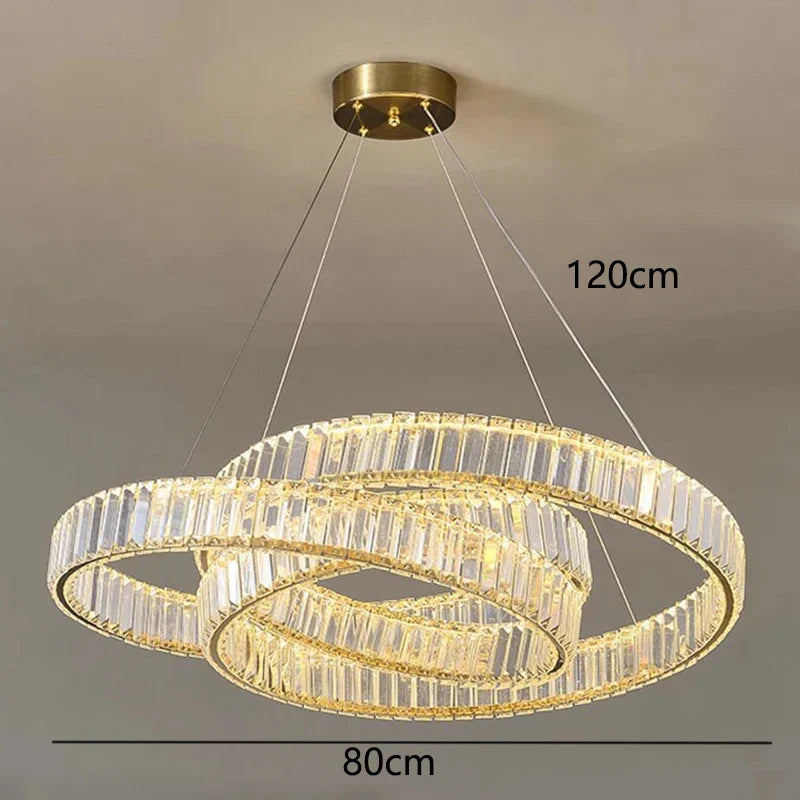 Intertwined gold rings with crystals form a suspended, modern chandelier; size: 120x80 cm.