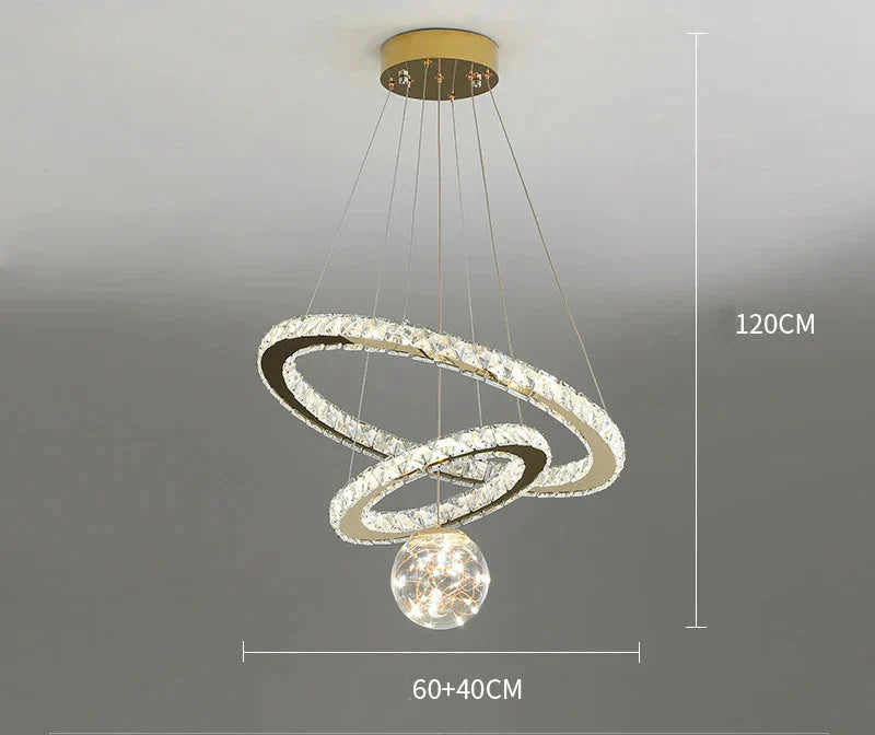 Modern gold chandelier with two LED rings, crystal glass ball, and round ceiling mount. 120 cm height.