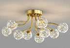 Gold chandelier with curved arms, each holding a glass globe filled with LED star lights.