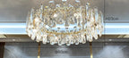 Gold-accented modern crystal LED chandelier, 80 cm wide, 23 cm high, with elongated reflective crystals.