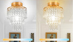 Two Maison Ornate Modern Crystal Art Deco Chandeliers with gold frames, one cool white, one warm yellow.