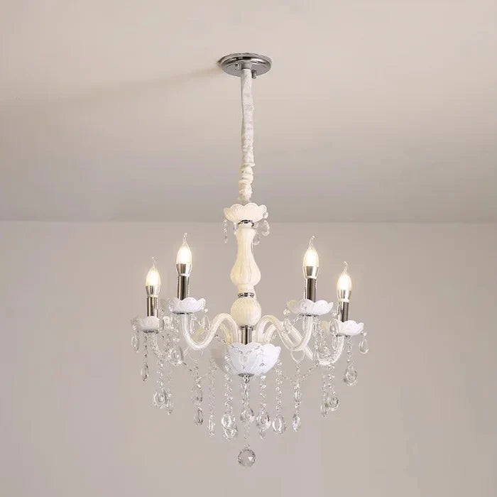 Baroque crystal chandelier with five candle bulbs, curved arms, and hanging crystals for elegant shine.