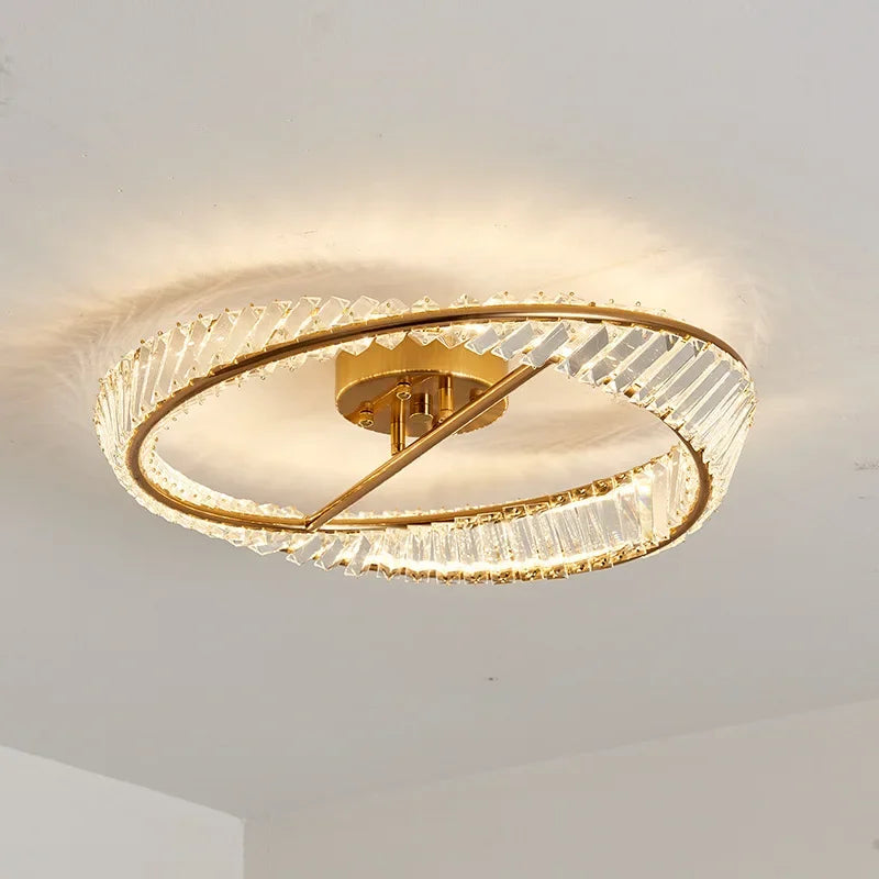 Circular gold chandelier with crystal accents, flush-mount design, dimmable LED, elegant contemporary style.