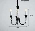 Three-arm vintage crystal chandelier in black and clear glass with candle-style LEDs, luxury finish.