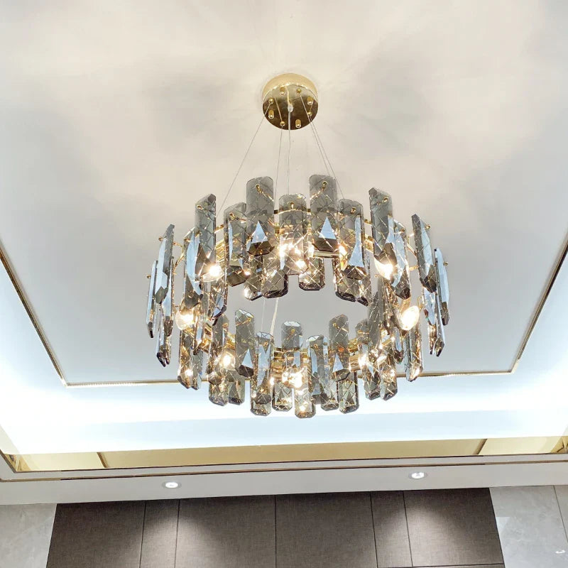 Elegant modern crystal LED chandelier with gold trim, glass pieces, and circular suspended design.