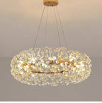 Gold-finished chandelier with LED lighting, dandelion-like crystals, and slim suspension cables.