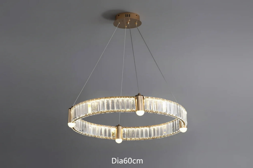 Crystal chandelier with gold LED rings, glass panels, and four bulbs suspended by thin cables.