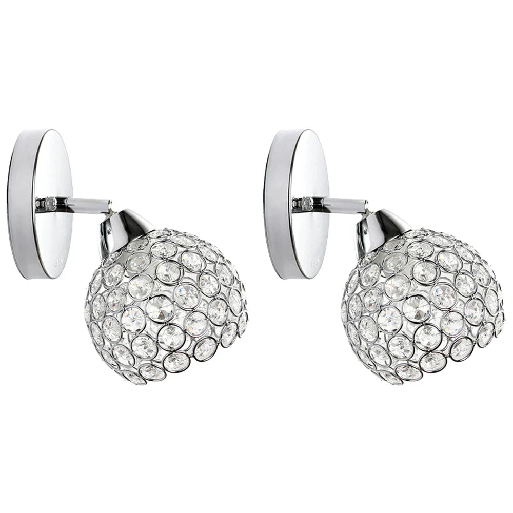 Modern chandelier-style lights with chrome bases and crystal-accented spherical shades, elegant and reflective.