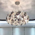 Geometric diamond crystal LED chandelier in modern stainless steel, creates sparkling light patterns.